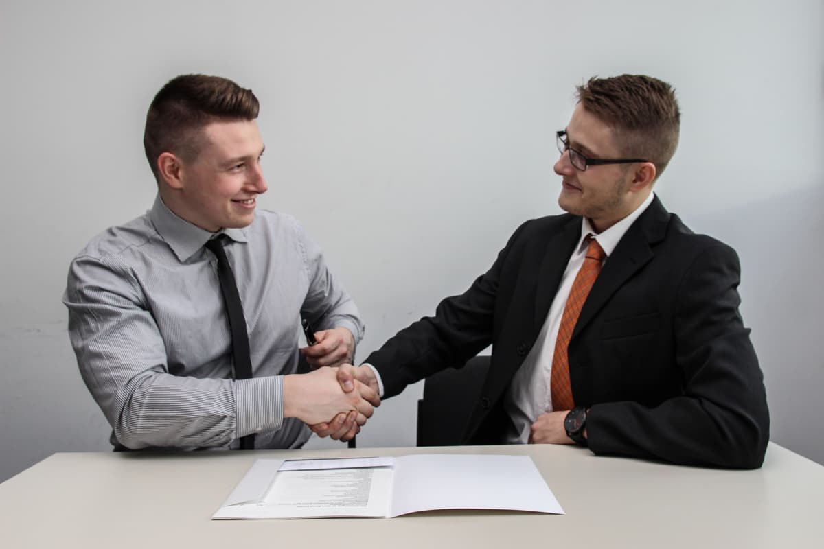 Series 7 tutor shaking hands with a student Series 7 tutor shaking hands with a student