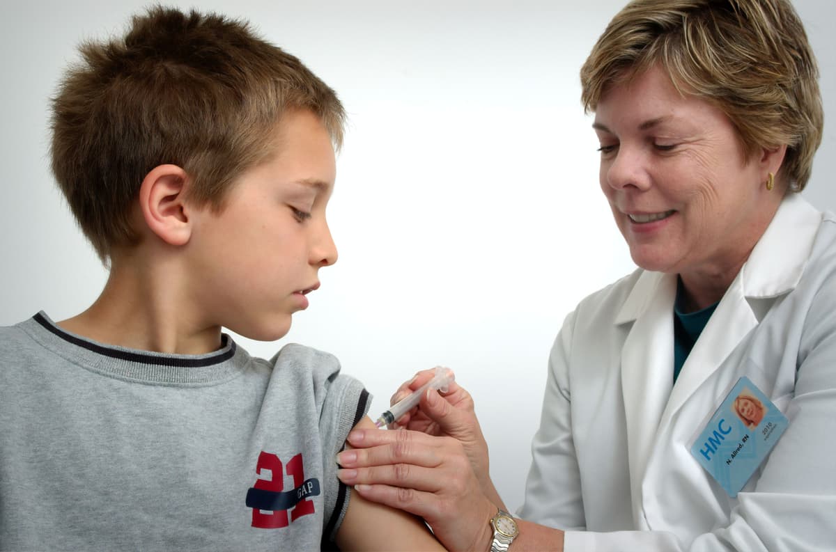 family medicine doctor administering a vaccine family medicine doctor administering a vaccine