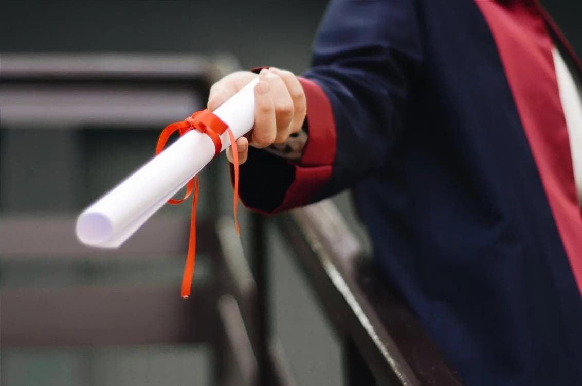 Person-holding-white-diploma